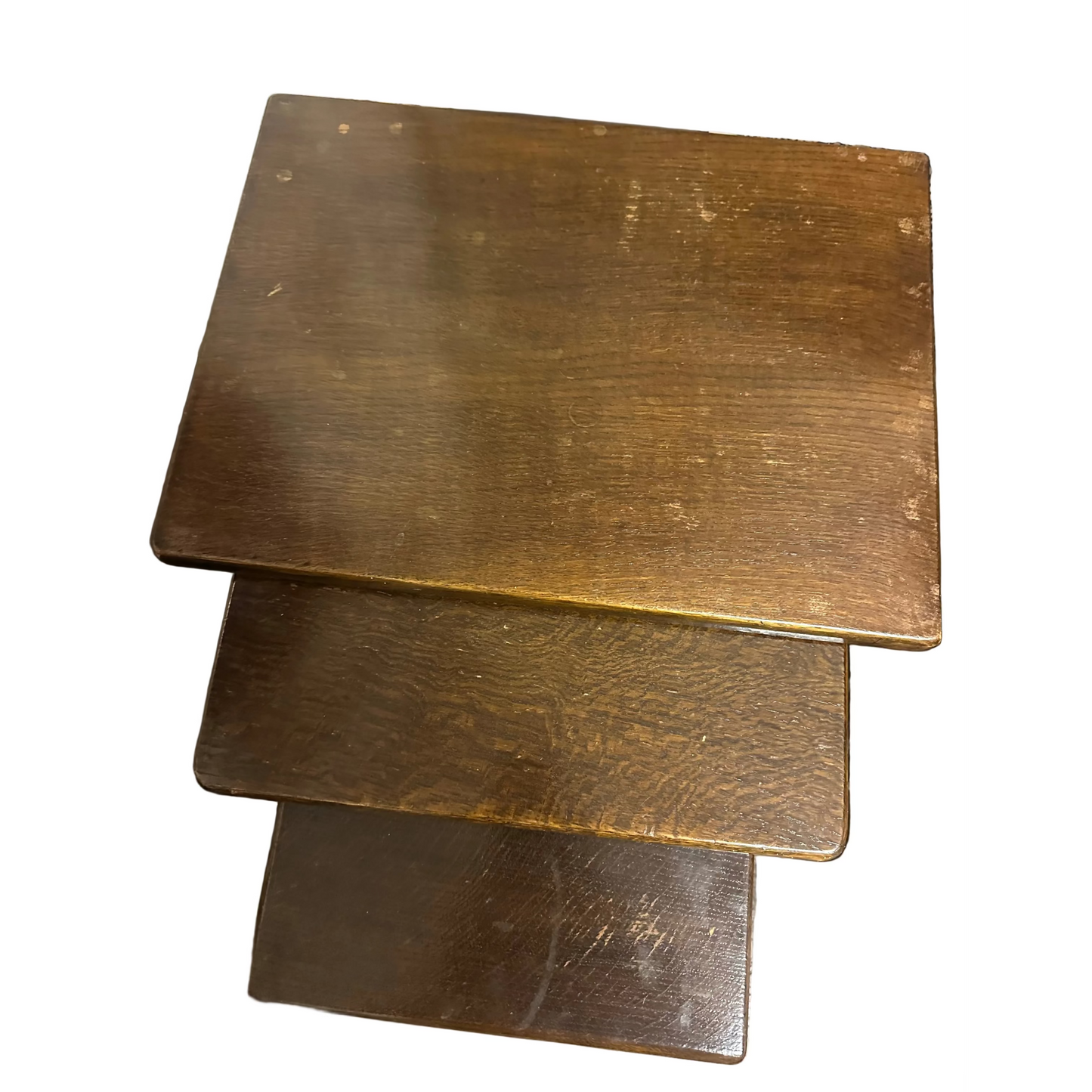 Three wooden stools stacked on top of each other with a blurred background.