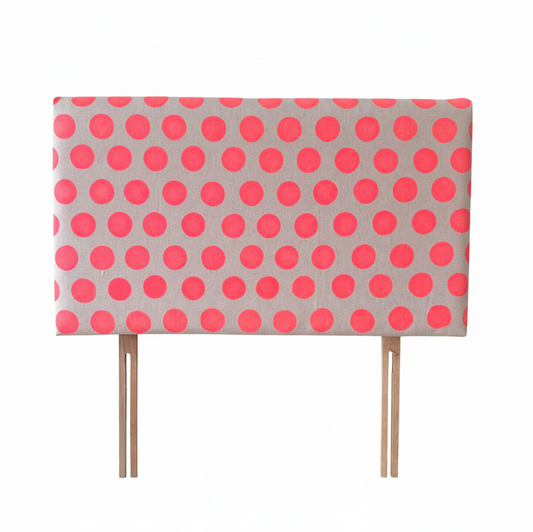 Polka dot headboard with pink dots on a gray background