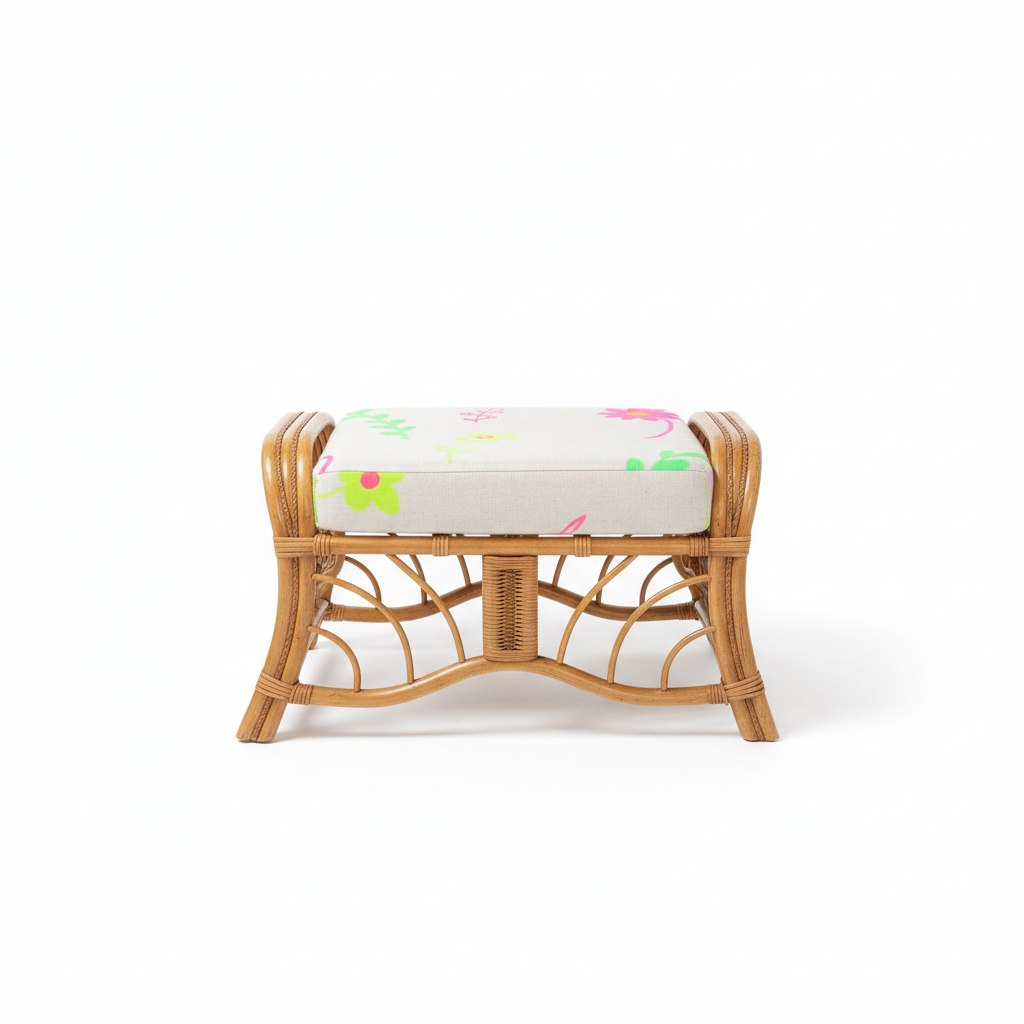 Wicker bamboo ottoman stool with a floral cushion on a white background