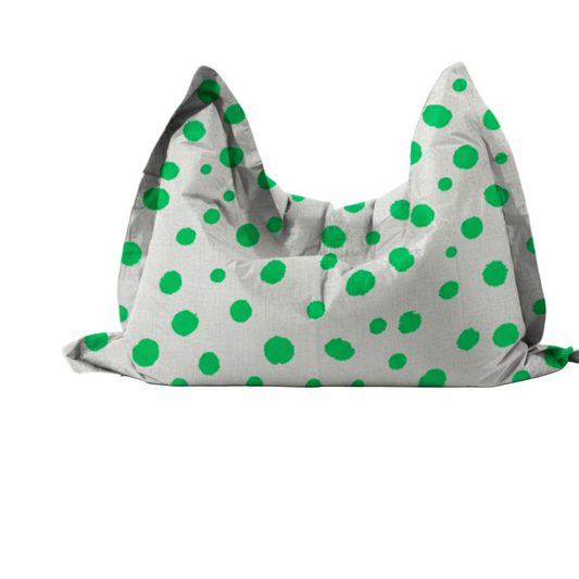 Gray pillow with green polka dots on a white background