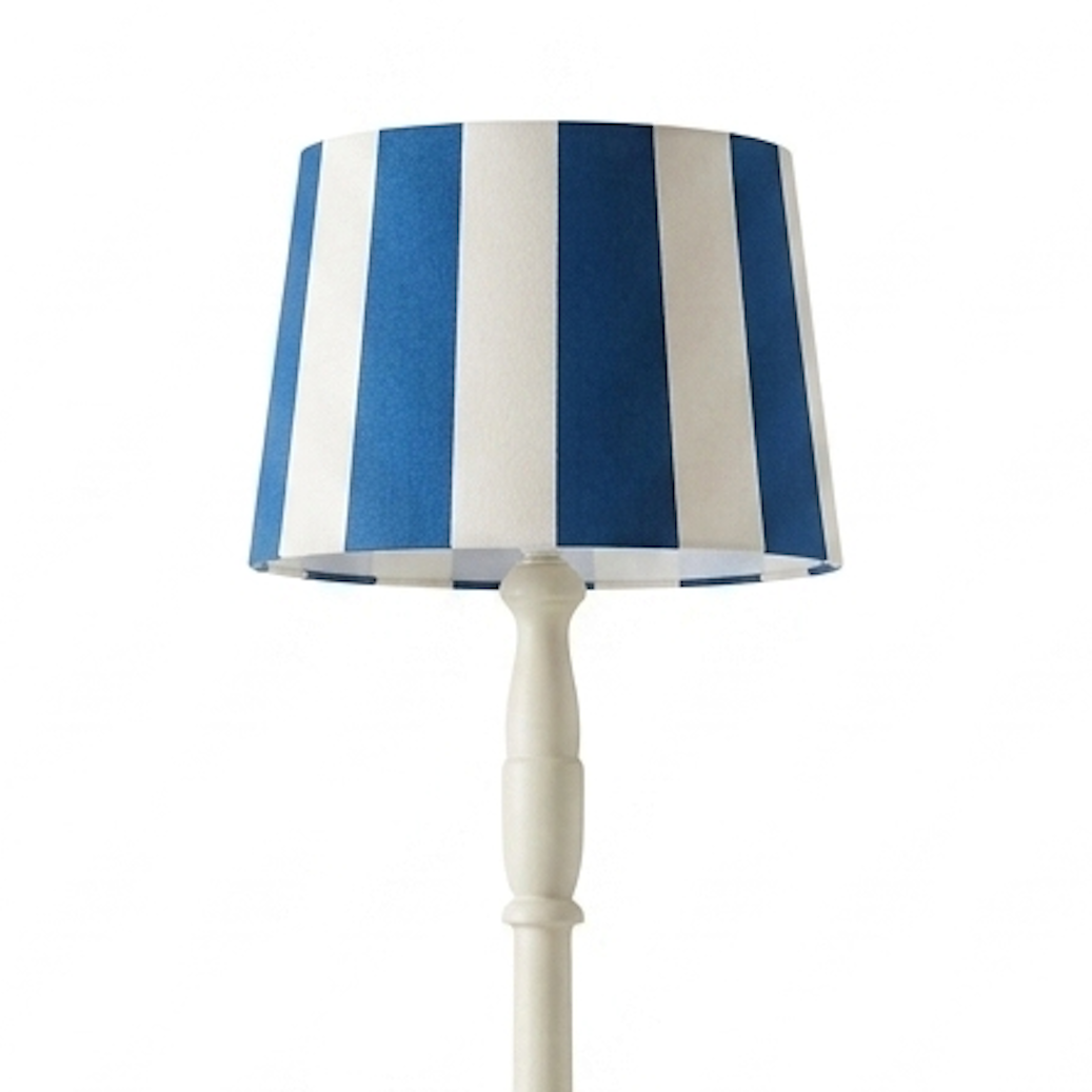 Lamp with a blue and white striped shade on a white background